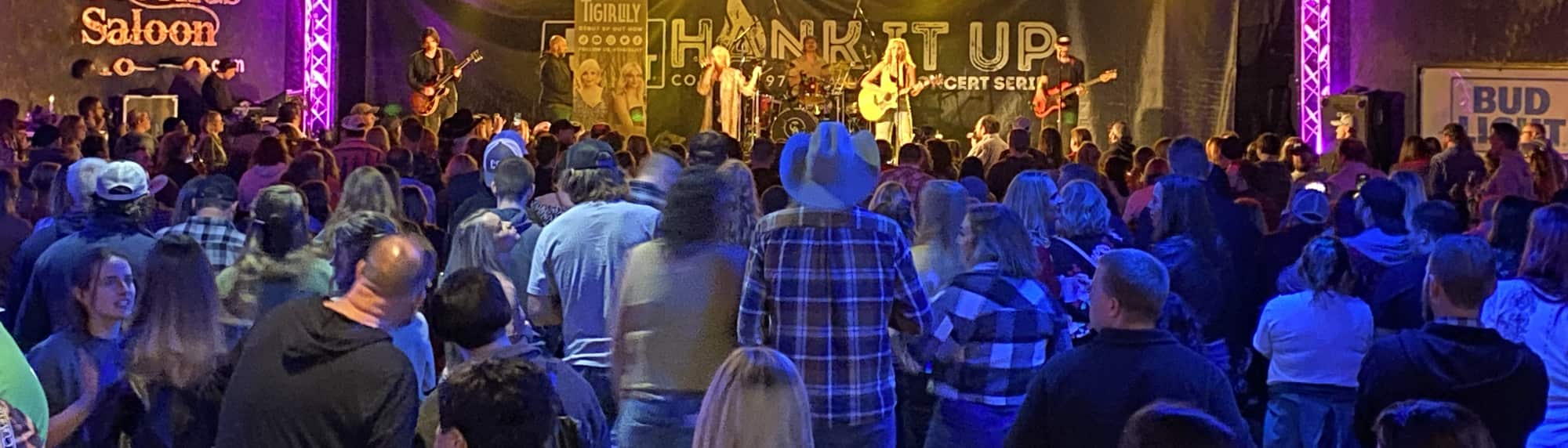 country concert with fans wearing cowboy hats Huntsville